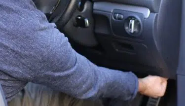 man plugging the adapter into the OBD port