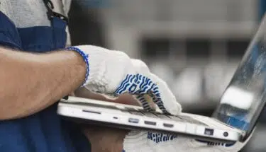 male automotive staff using a laptop