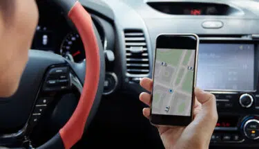 female driving while using smart phone