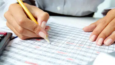 businesswoman checking and calculating the records