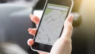Close-up of female hand holding her phone using navigation