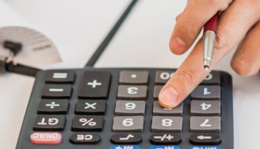 Close-up of businessman calculating